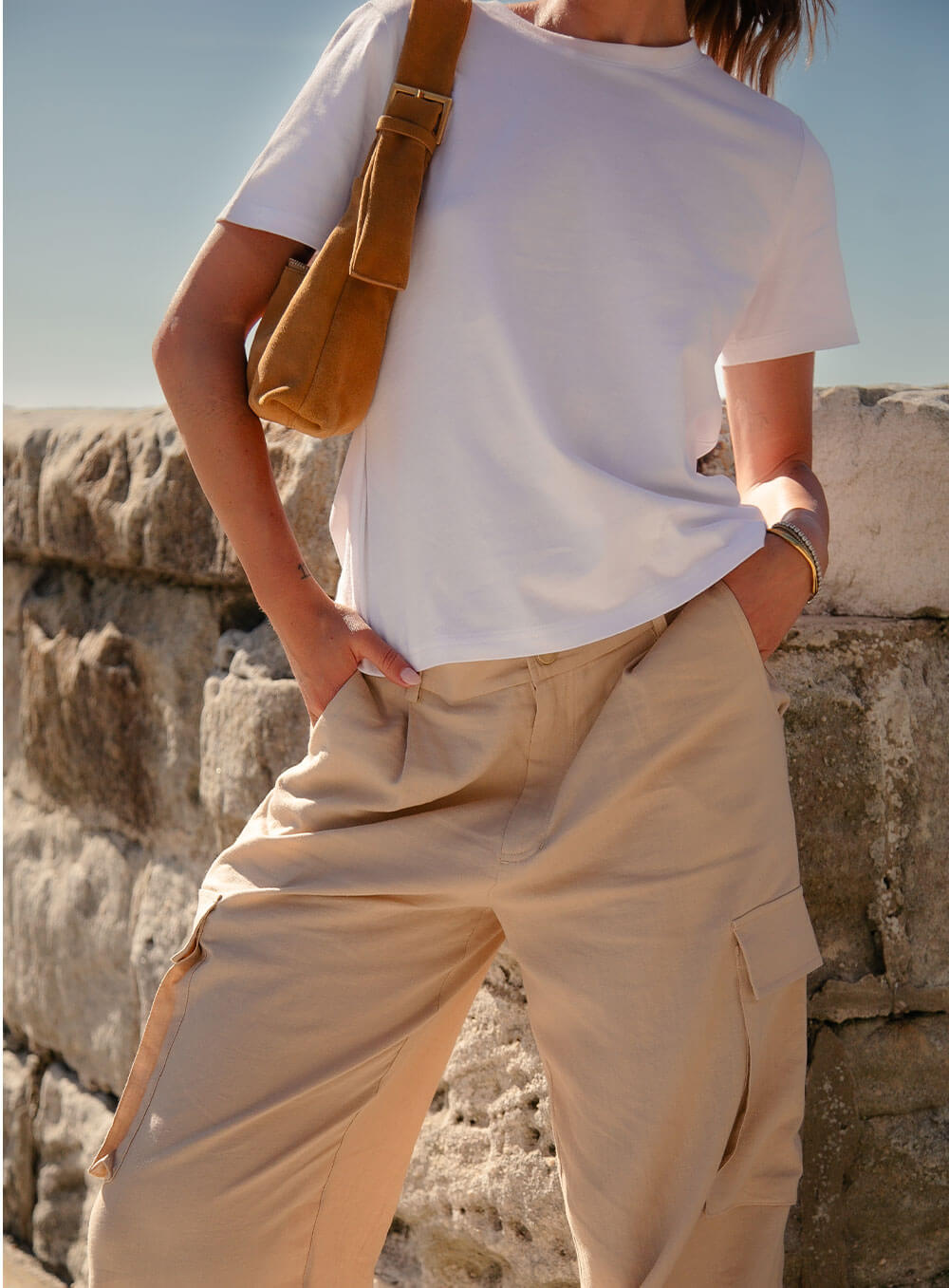 Athena Linen Cargo Pant in beige is 100% Linen, elastic waistband at back, belt loops, slightly tapered towards the hem, 2 Pockets at back, 2 Pockets on side leg