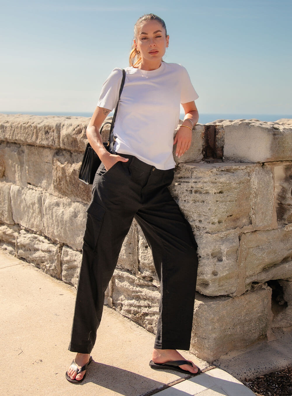 Athena Linen Cargo Pant in black is 100% Linen, elastic waistband at back, belt loops, slightly tapered towards the hem, 2 Pockets at back, 2 Pockets on side leg