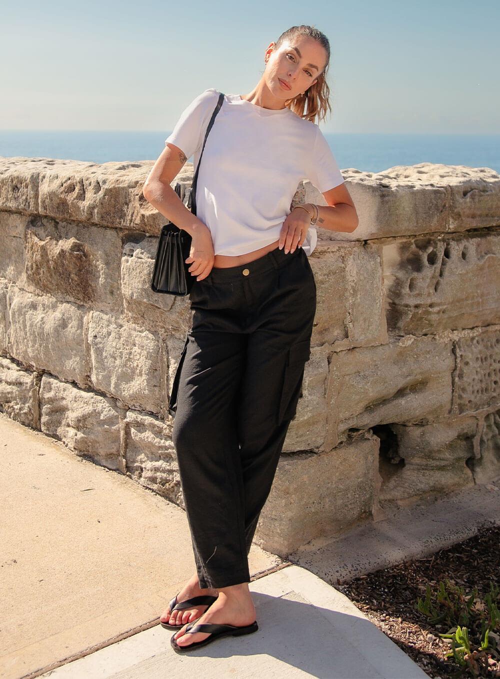 Athena Linen Cargo Pant in black is 100% Linen, elastic waistband at back, belt loops, slightly tapered towards the hem, 2 Pockets at back, 2 Pockets on side leg