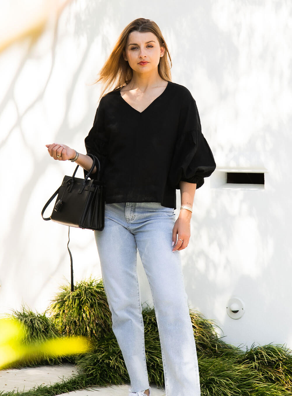 The Celeste Top in black has an elasticised cuff, ruched sleeve detail, v neck with collar detail and breathable with soft washed linen