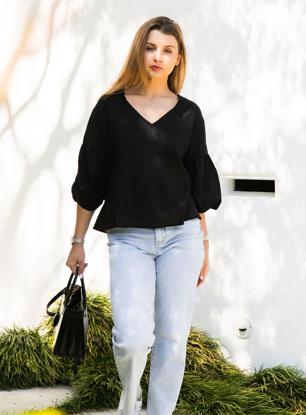 The Celeste Top in black has an elasticised cuff, ruched sleeve detail, v neck with collar detail and breathable with soft washed linen