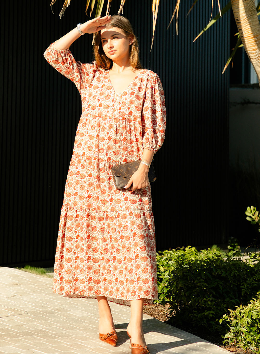 The Charlize linen dress has an all over brownie red print on a cream coloured background. It's lined, elasticated Sleeve, tiered style and front bodice detailing