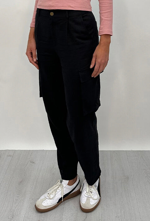 Athena Linen Cargo Pant in black is 100% Linen, elastic waistband at back, belt loops, slightly tapered towards the hem, 2 Pockets at back, 2 Pockets on side leg