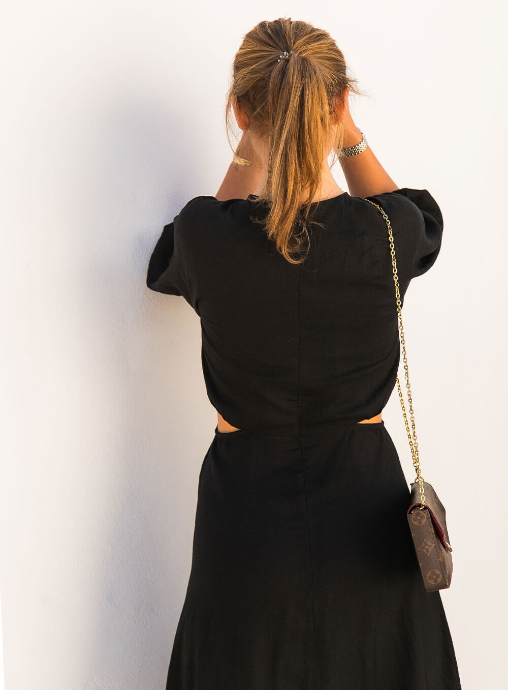 The Margot Linen mid length dress in black features an invisible zip in centre back, strategically placed side cut outs. Circle detail centre front.
