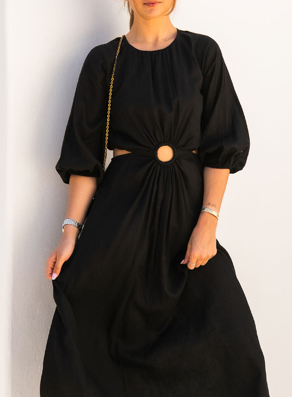The Margot Linen mid length dress in black features an invisible zip in centre back, strategically placed side cut outs. Circle detail centre front.