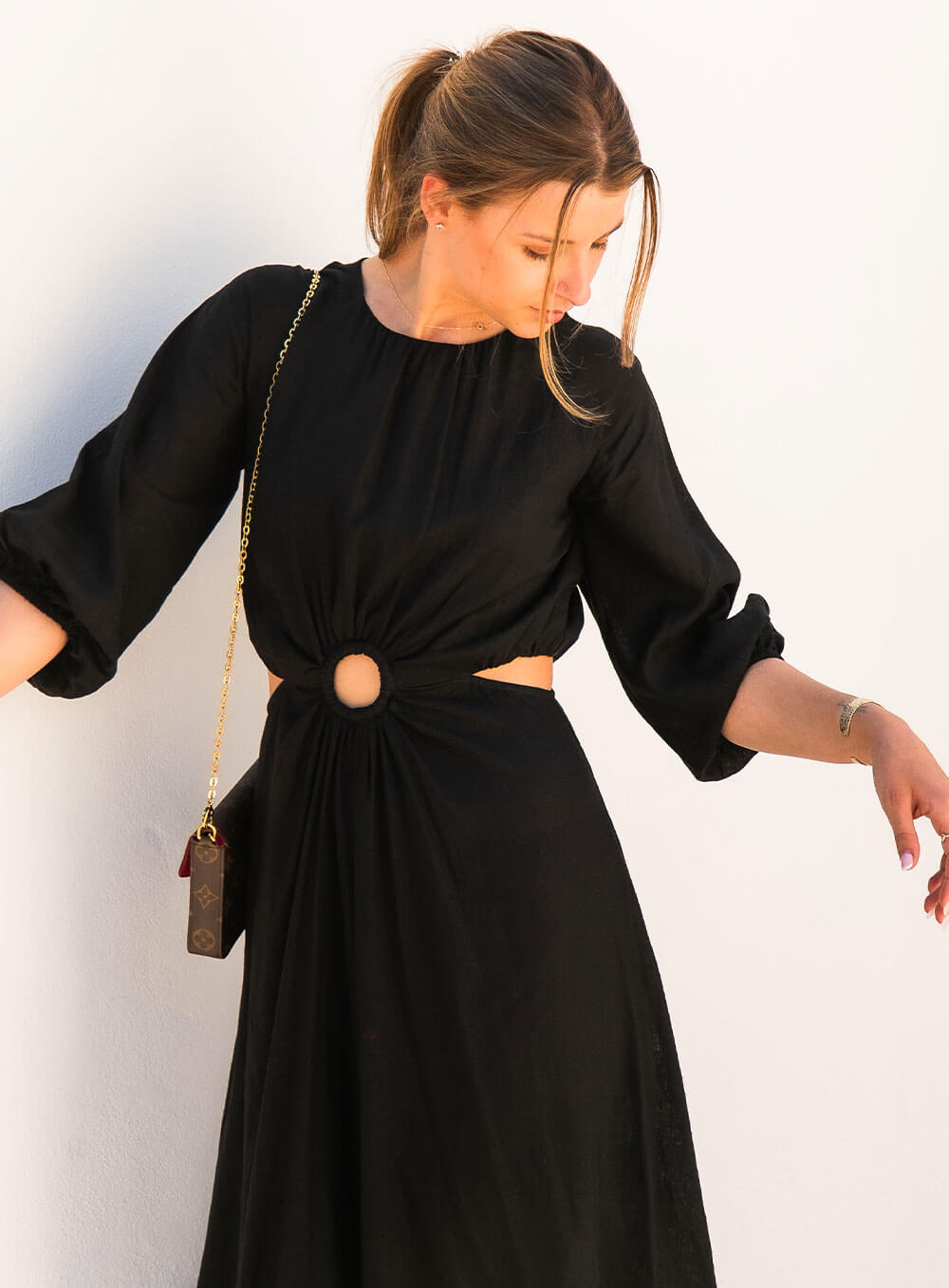 The Margot Linen mid length dress in black features an invisible zip in centre back, strategically placed side cut outs. Circle detail centre front.