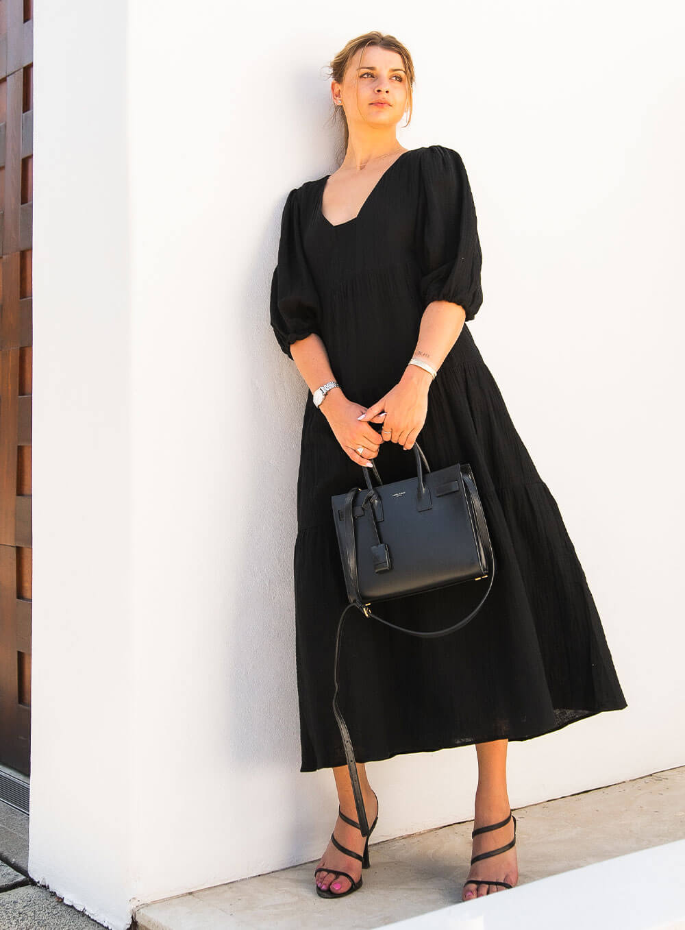 The Olive Dress in black is mid length, lined, features elasticated sleeve, tiered style front bodice detailing.
