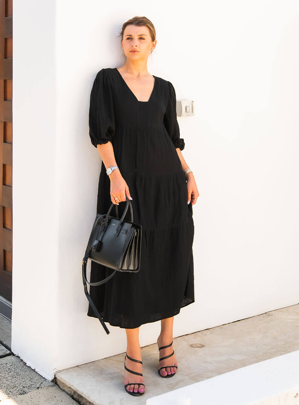The Olive Dress in black is mid length, lined, features elasticated sleeve, tiered style front bodice detailing.
