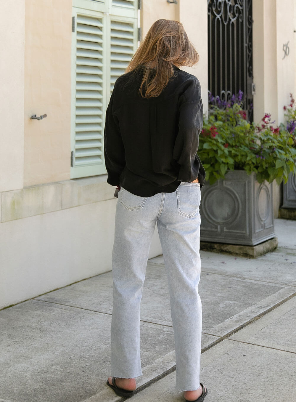 The Sienna Cupro shirt in black is a long sleeve soft velvet feeling long sleeve shirt with 2 chest pockets, scoop hem and self fabric buttons down the front.