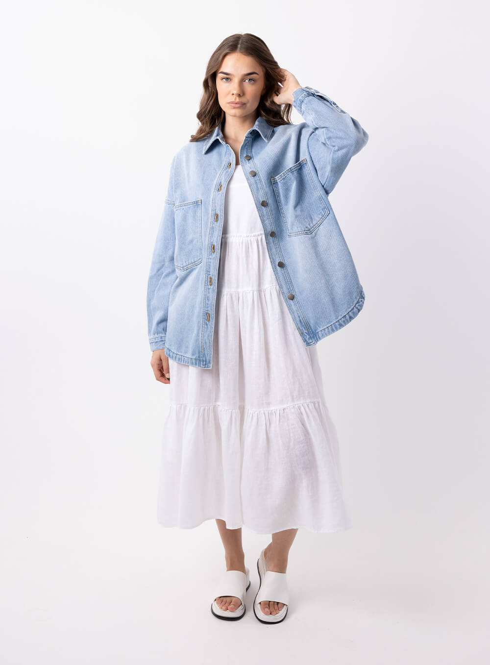 The Wake Up Denim Jacket in blue features full button through front, collar at the neck line, 2 large chest pockets, 2 side pockets, functional button down cuff adn scoop hem.