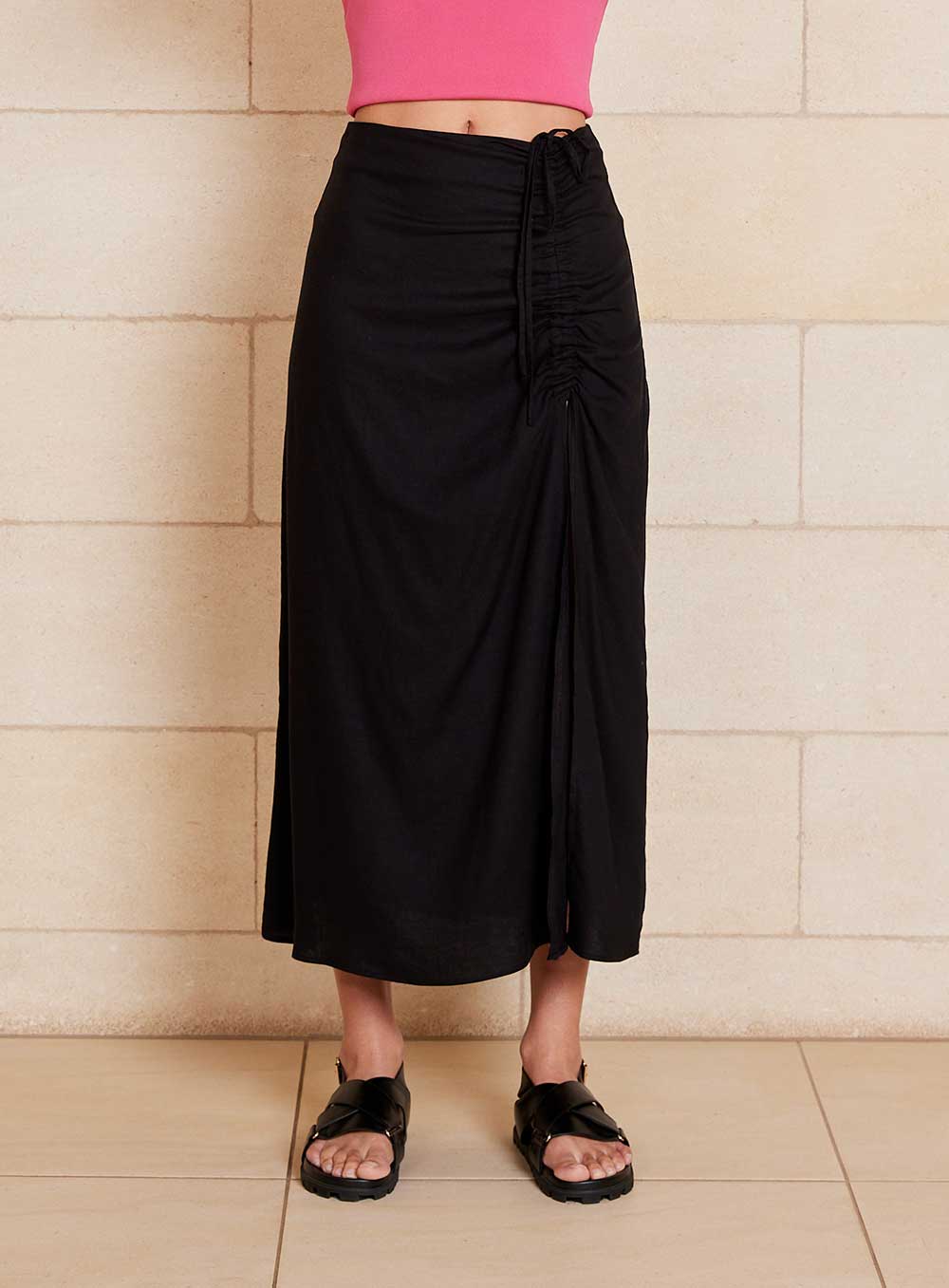 The Lily Skirt in black features a ruched split detailing that adds both shape and texture, functional ruching with tie leg splits and invisible zip back seam.