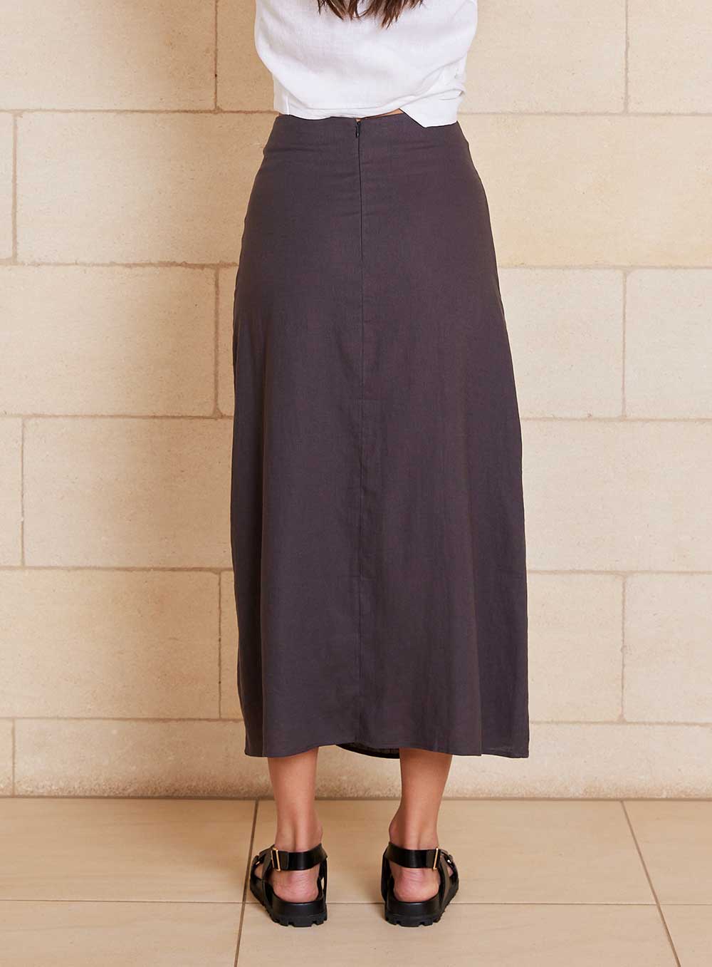 The Lily Skirt in charcoal features a ruched split detailing that adds both shape and texture, functional ruching with tie leg splits and invisible zip back seam.