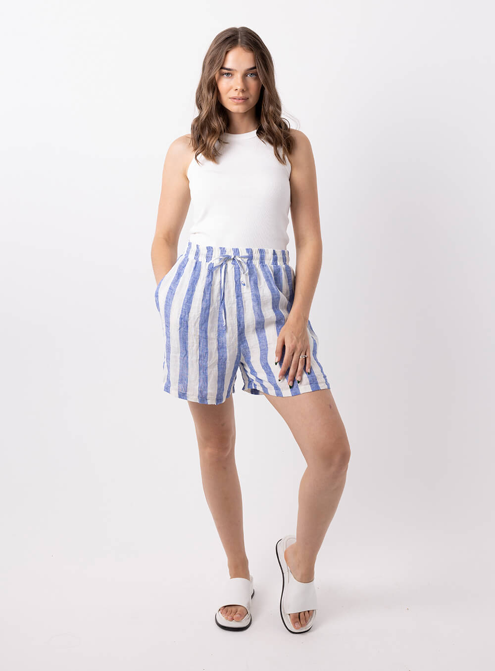 The Charlie stripe linen short in blue and white is made from 100% breathable linen, featuring wide elastic waistband with tie, finishes mid thigh with finished hem