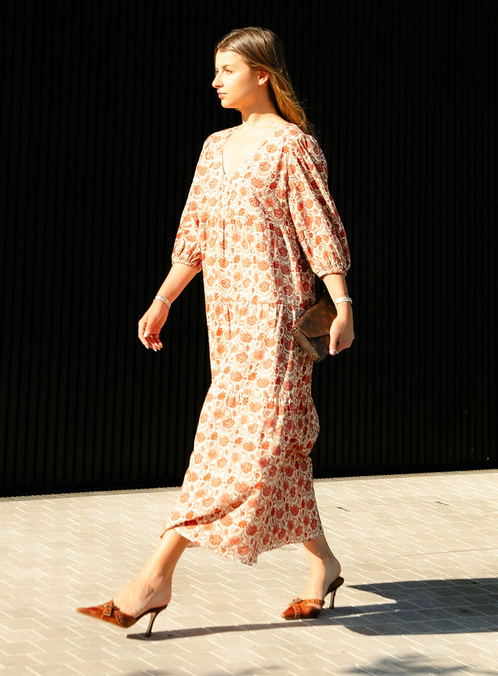 The Charlize linen dress has an all over brownie red print on a cream coloured background. It's lined, elasticated Sleeve, tiered style and front bodice detailing