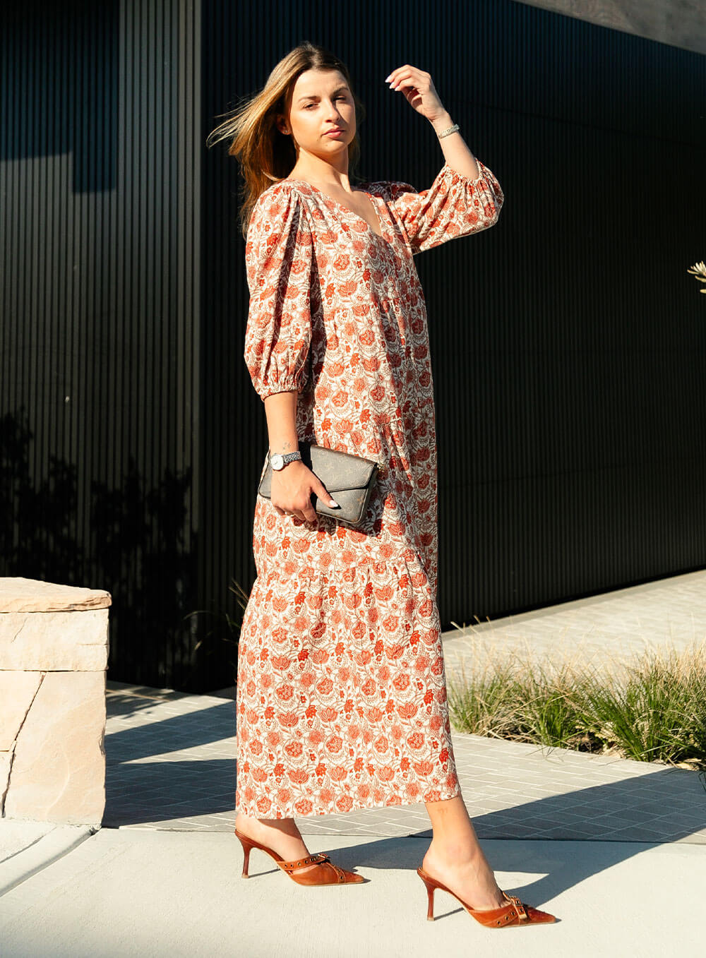 The Charlize linen dress has an all over brownie red print on a cream coloured background. It's lined, elasticated Sleeve, tiered style and front bodice detailing