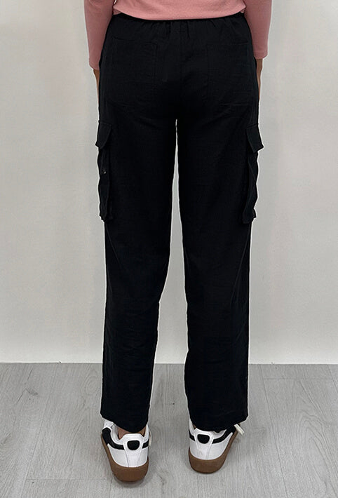 Athena Linen Cargo Pant in black is 100% Linen, elastic waistband at back, belt loops, slightly tapered towards the hem, 2 Pockets at back, 2 Pockets on side leg