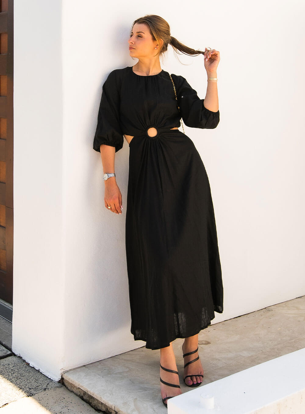 The Margot Linen mid length dress in black features an invisible zip in centre back, strategically placed side cut outs. Circle detail centre front.