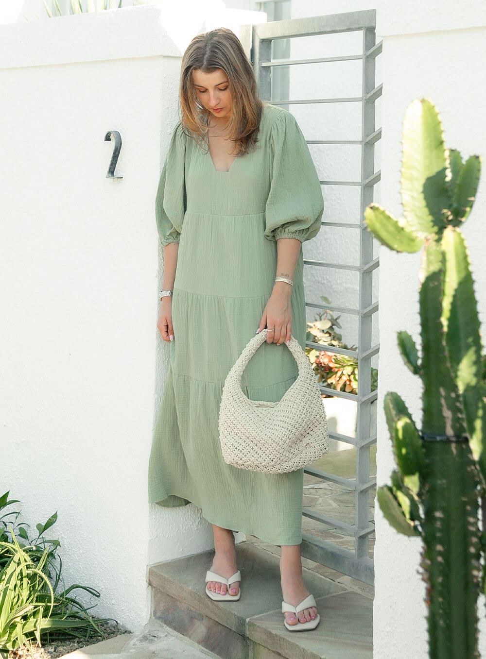 The Olive Dress in Sage is mid length, lined, features elasticated sleeve, tiered style front bodice detailing.