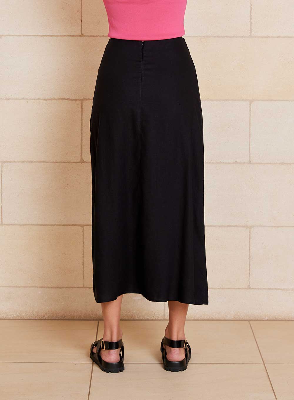 The Lily Skirt in black features a ruched split detailing that adds both shape and texture, functional ruching with tie leg splits and invisible zip back seam.